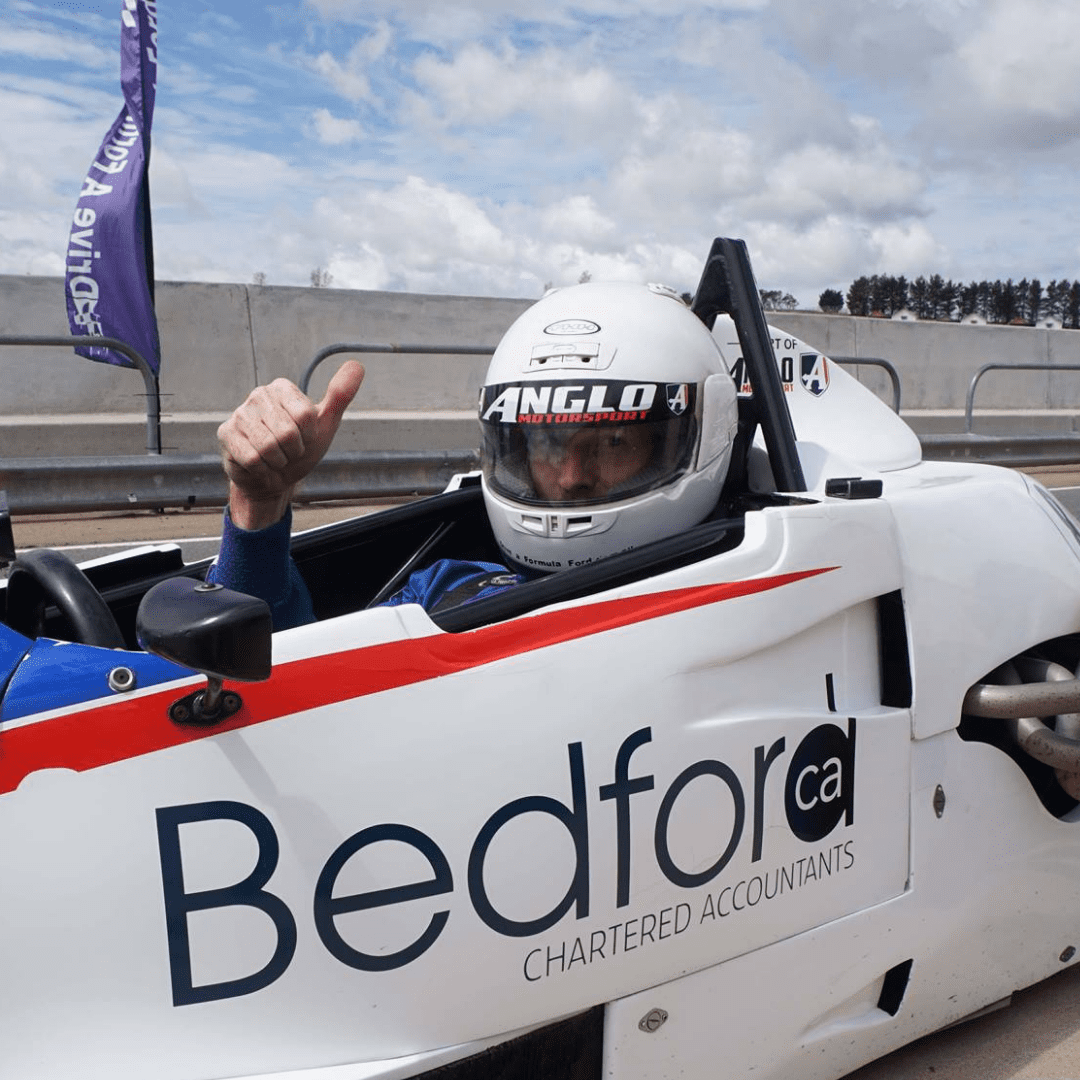 Picture of personal trainer Rhys Brooks in a race car. World class personal training and online personal training, Sydney, Australia